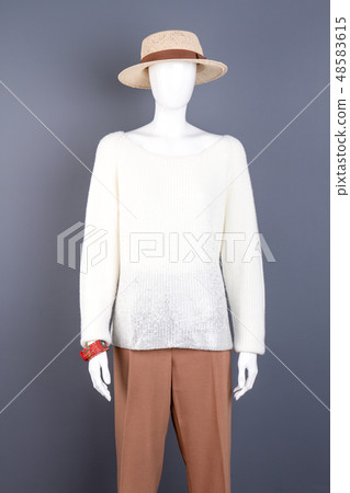 Mannequin in straw hat, grey background. 48583615