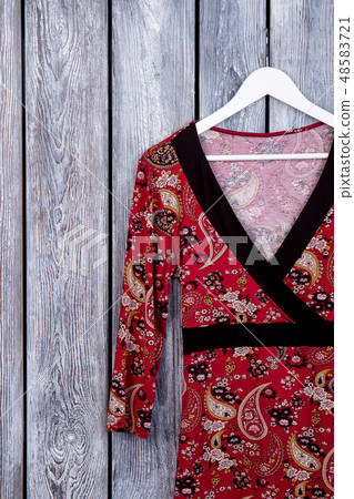 Female clothing hanging on hanger. 48583721