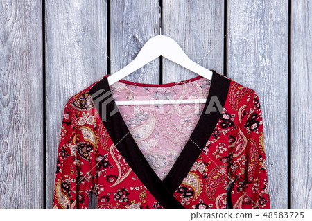 Feminine patterned clothes on hanger. Feminine patterned clothes on hanger. 48583725