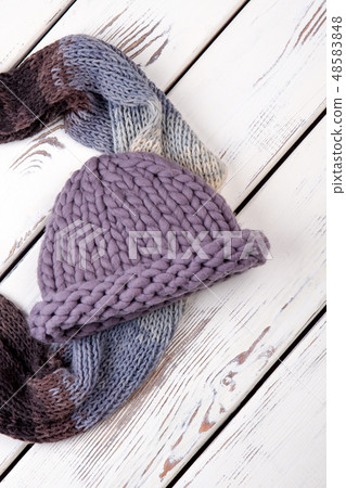 Women scarf and hat on wooden background. Women scarf and hat on wooden background. 48583848