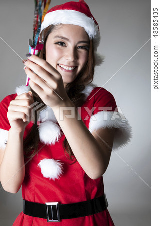 A woman in Santa costume A woman in Santa costume 48585435