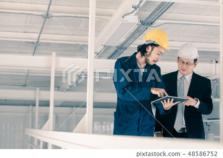 Young engineer present work to executive engineer. Young engineer present work to executive engineer. 48586752