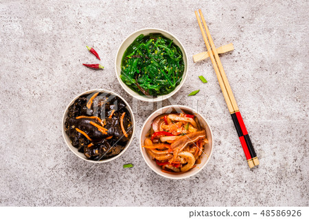 Korean pickled food set and chopsticks on gray ba Korean pickled food set and chopsticks on gray ba 48586926