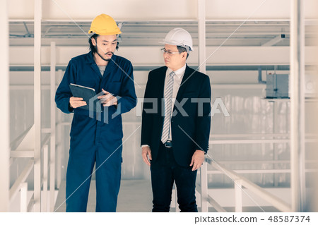 Young engineer present work to executive engineer. Young engineer present work to executive engineer. 48587374