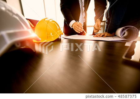 Businessman and engineer reviewing plan design Businessman and engineer reviewing plan design 48587375