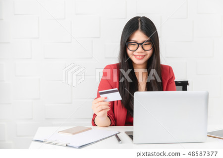 Business woman card hold in her hand to office Business woman card hold in her hand to office 48587377