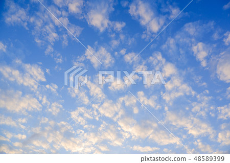 The image of the bright blue sky has some clouds. The image of the bright blue sky has some clouds. 48589399