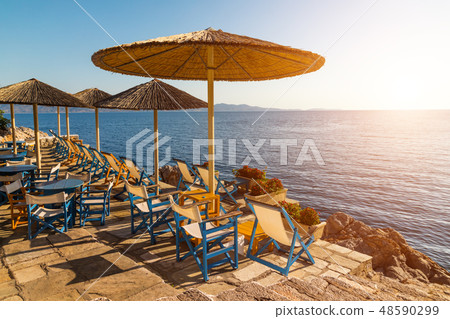 Cafe with umbrellas overlooking the sea. Hydra island, Greece. Cafe with umbrellas overlooking the sea. Hydra island, Greece. 48590299