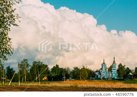 Wooden old church in the village of Red Partisan 48590776