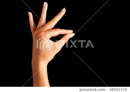 Woman hand holding something with two fingers Woman hand holding something with two fingers 48591519