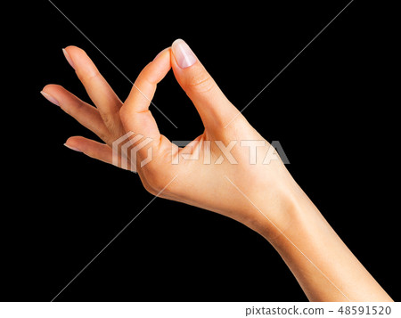 Woman hand holding something with two fingers Woman hand holding something with two fingers 48591520