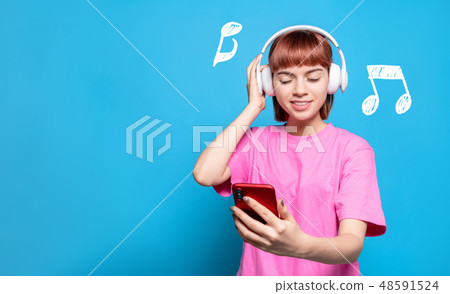 A woman listening to music 48591524