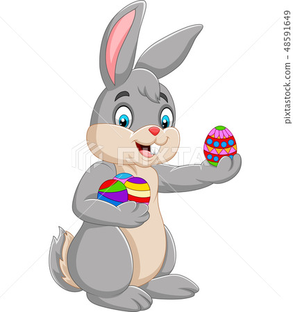 Easter Bunny holding a decorated an egg 48591649