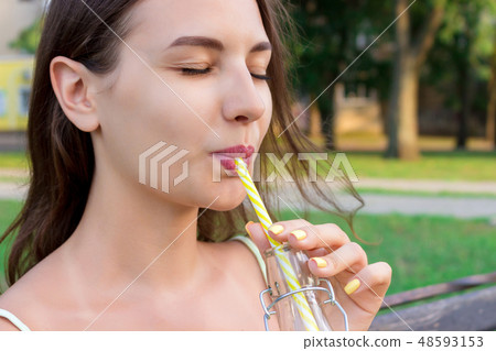 Closeup girl with a bottle of fresh juice 48593153