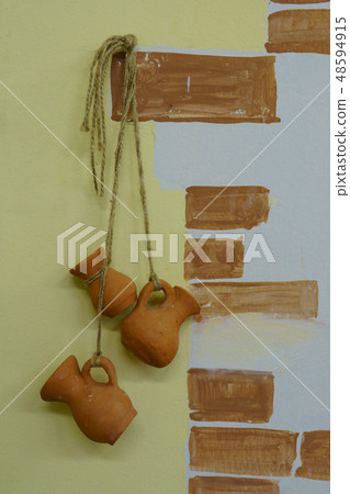 Earthenware jugs hanging on the ropes 48594915