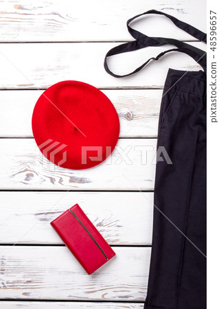 Female black trousers and red beret. 48596657