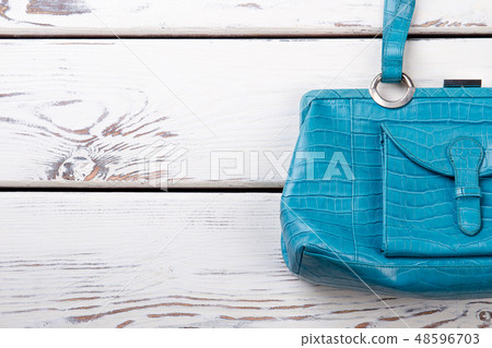 Female blue leather handbag, copy space. 48596703