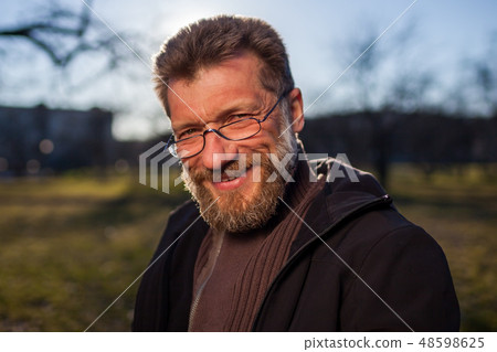 mature man in glasses on a background of nature. mature man in glasses on a background of nature. 48598625