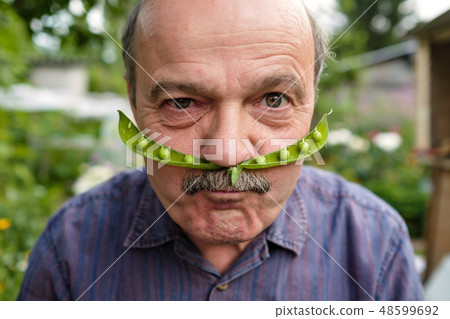 An elderly man is fooling around.   48599692