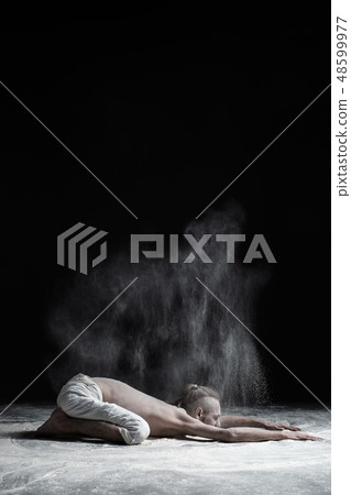 man practices yoga asana balasana child's pose. man practices yoga asana balasana child's pose. 48599977
