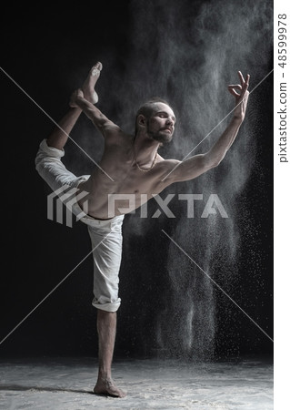 man practices yoga or pilates man practices yoga or pilates 48599978
