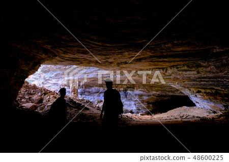 Two unrecognizable tourists at the entrance of Gruta Da Lapa Doce, cave in Iraquara, Chapada Two unrecognizable tourists at the entrance of Gruta Da Lapa Doce, cave in Iraquara, Chapada 48600225