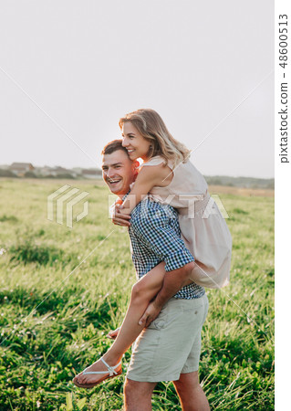 Close up romantic beauty portrait of happy couple in love hugs and having fun, evening sunlights 48600513