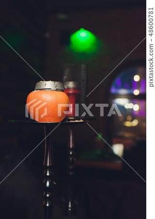 Luxury hookah with orange. Exotic bowl with fruit. Hookah lounge. Fruits and coals. Glamours relax Luxury hookah with orange. Exotic bowl with fruit. Hookah lounge. Fruits and coals. Glamours relax 48600781