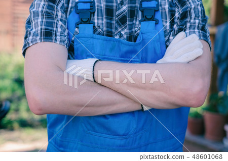 Happy young gardener with crossed hands Happy young gardener with crossed hands 48601068