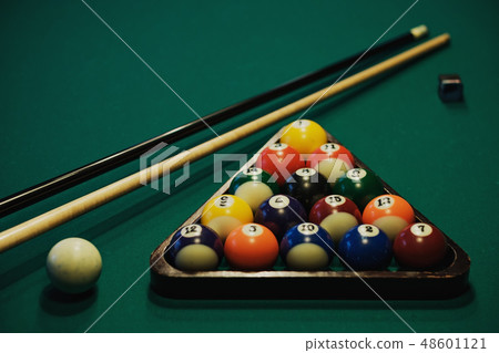 Billiards balls and cue on green billiards table. Billiards balls and cue on green billiards table. 48601121