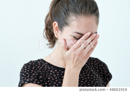 Playful shy woman hiding face with her hands Playful shy woman hiding face with her hands 48601919