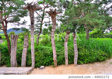 A traditional sculpture of a wooden sculpture guarding the entrance of an old rural village in Korea A traditional sculpture of a wooden sculpture guarding the entrance of an old rural village in Korea 48602272