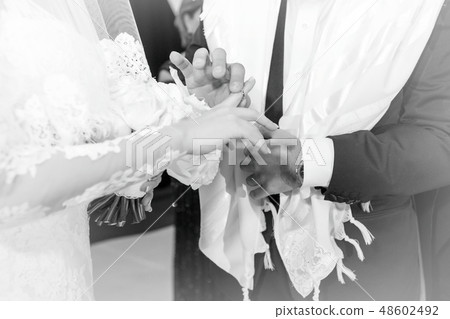 The wedding rings. Hands of the bride and groom with wedding rings. The wedding rings. Hands of the bride and groom with wedding rings. 48602492