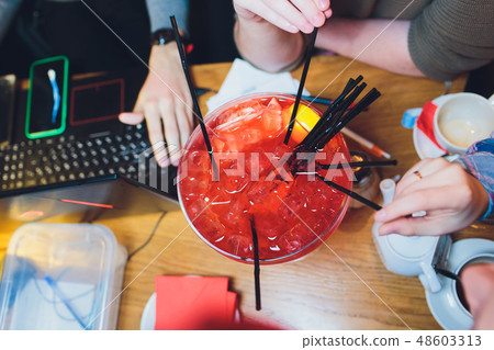 Happy friends enjoying summer party outdoor drinking extra large cocktail together-Young diverse Happy friends enjoying summer party outdoor drinking extra large cocktail together-Young diverse 48603313
