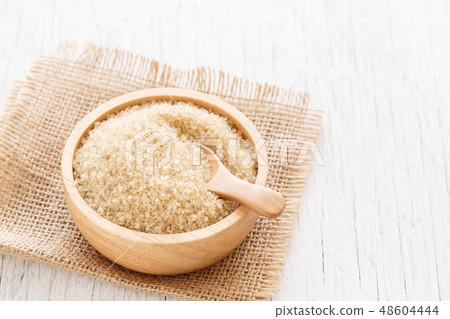 brown sugar and wood spoon in brown bowl brown sugar and wood spoon in brown bowl 48604444