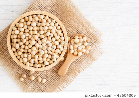 White wood floor with wooden cup with soybean 48604809