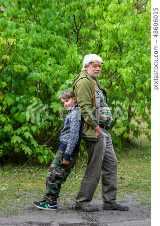 Happy senior and boy in green park. 48606015