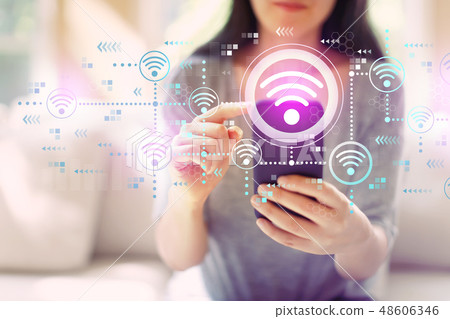 Wifi concept with woman using a smartphone Wifi concept with woman using a smartphone 48606346