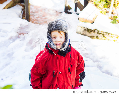 Little blonde boy in winter outerwear outdoors Little blonde boy in winter outerwear outdoors 48607036