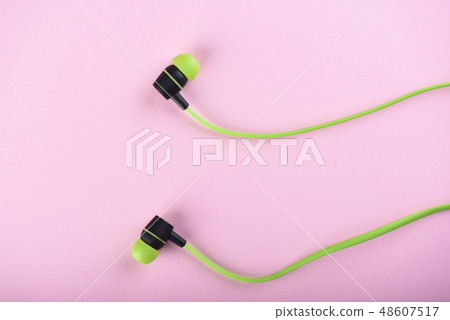 Green headphones or earphones isolated 48607517