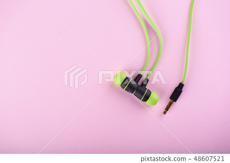 Green headphones or earphones isolated 48607521