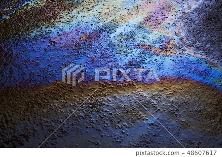 Background texture of an oil spill on road 48607617