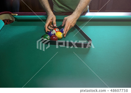 referee preparing the billiard balls on pool table 48607738