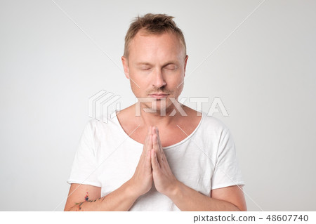 Portrait of caucasian man thinking and praying. 48607740