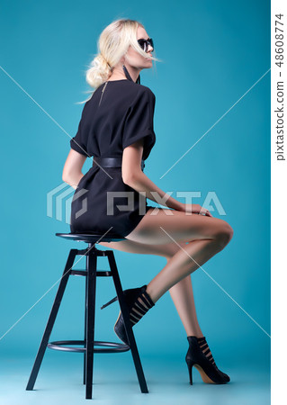 Beautiful and sexy blonde model girl, stylish hairstyle, in fashionable black tight dress with Beautiful and sexy blonde model girl, stylish hairstyle, in fashionable black tight dress with 48608774