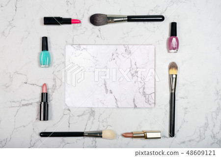 Frame made of makeup brushes with marble slab on white marble texture. Lipsticks, brushes and nail 48609121