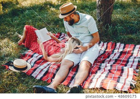 Beautiful couple spend time in a summer park 48609175