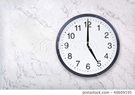 Wall clock show five o'clock on white marble texture. Office clock show 5pm or 5am 48609195