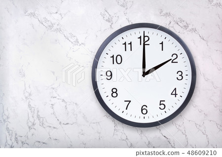 Wall clock show two o'clock on white marble texture. Office clock show 2pm or 2am Wall clock show two o'clock on white marble texture. Office clock show 2pm or 2am 48609210