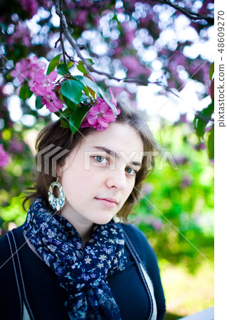 girl enjoying of blossoming tree flowers smell. girl enjoying of blossoming tree flowers smell. 48609270